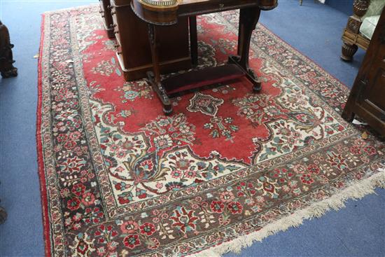A modern Persian red-ground carpet with polychrome figured floral central medallion, 330cm x 220cm